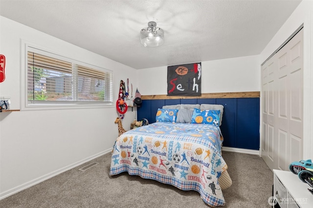 755 Elm St, Raymond, WA 98577 - carpeted bedroom with a closet and a textured ceiling
