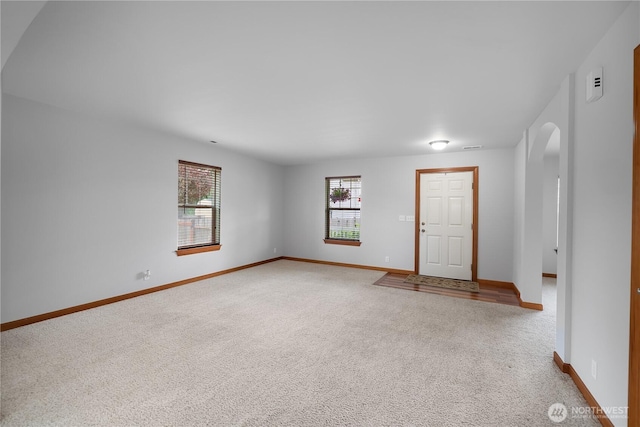516 Emerald Ct SE, Rainier, WA 98576 - carpeted entryway featuring baseboards and arched walkways