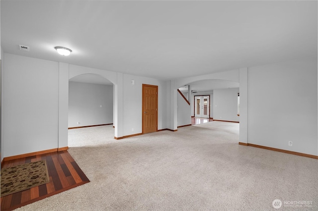 516 Emerald Ct SE, Rainier, WA 98576 - carpeted spare room with arched walkways and stairway