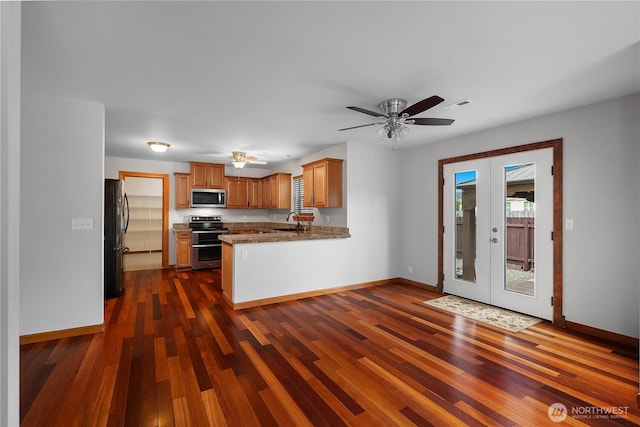 516 Emerald Ct SE, Rainier, WA 98576 - kitchen with stainless steel appliances, a peninsula, french doors, and dark wood finished floors
