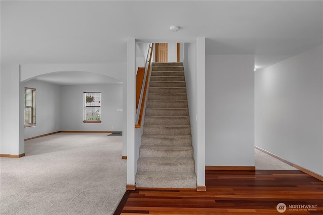 516 Emerald Ct SE, Rainier, WA 98576 - staircase with arched walkways, carpet, and wood finished floors