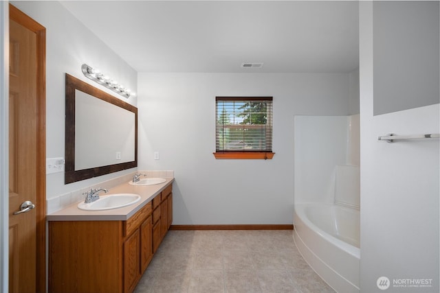516 Emerald Ct SE, Rainier, WA 98576 - bathroom with double vanity, tile patterned floors, and  shower combination