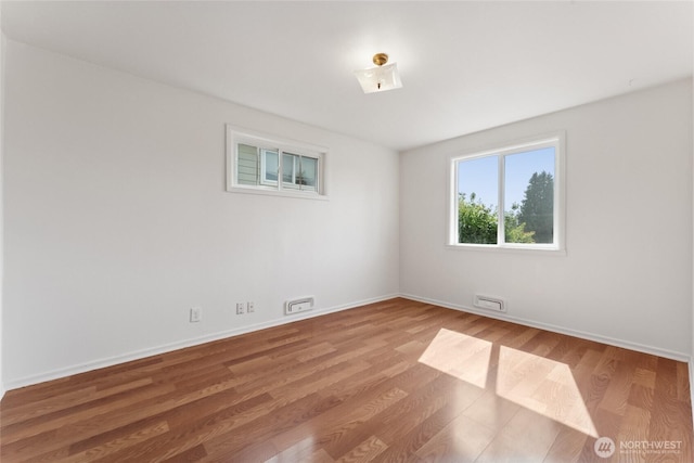 2117 S Ash St, Tacoma, WA 98405 - empty room featuring wood finished floors and baseboards