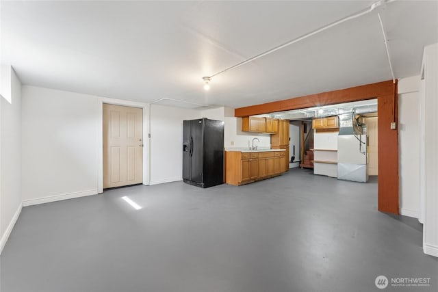 2117 S Ash St, Tacoma, WA 98405 - kitchen with black fridge with ice dispenser, finished concrete flooring, light countertops, brown cabinetry, and fridge
