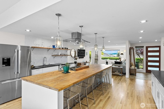11017 Forest Ave S, Seattle, WA 98178 - kitchen featuring stainless steel fridge with ice dispenser, recessed lighting, white cabinetry, butcher block counters, and light wood-type flooring