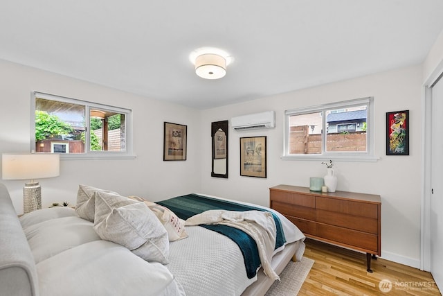 11017 Forest Ave S, Seattle, WA 98178 - bedroom featuring a wall mounted AC and light wood-type flooring