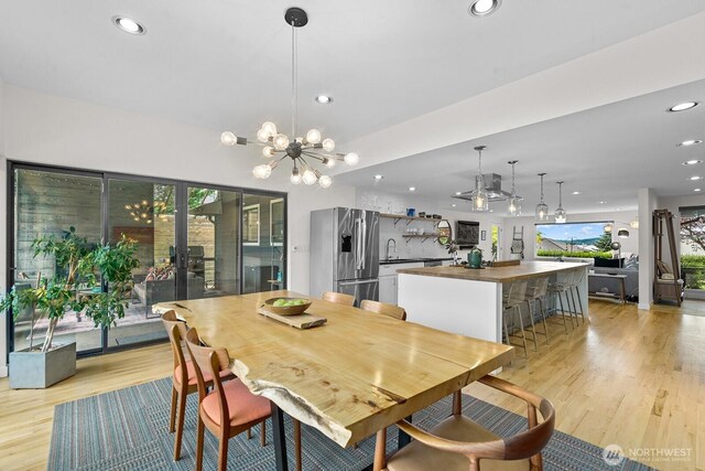 11017 Forest Ave S, Seattle, WA 98178 - dining space with a chandelier, light wood finished floors, recessed lighting, and french doors