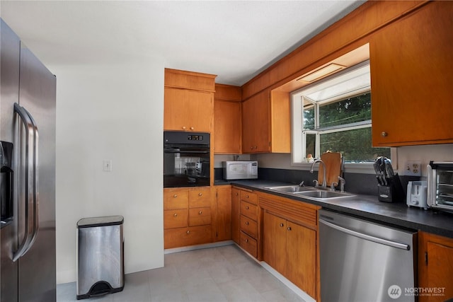 29929 4th Ave SW, Federal Way, WA 98023 - kitchen with stainless steel appliances, dark countertops, and brown cabinetry