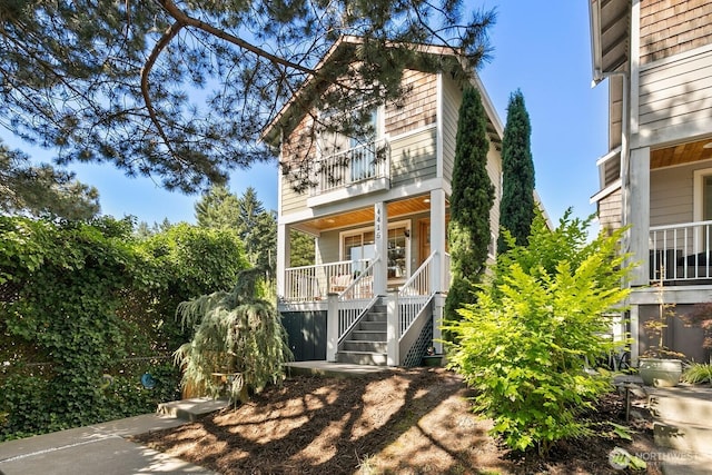 4415 40th Ave SW, Seattle, WA 98116 - view of front of property featuring a balcony, stairway, and covered porch