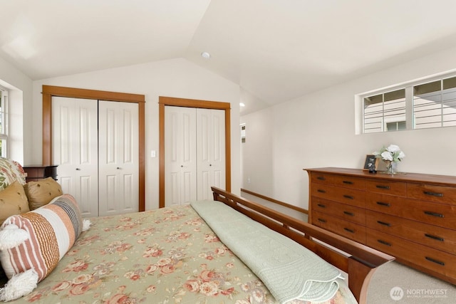 4415 40th Ave SW, Seattle, WA 98116 - carpeted bedroom featuring vaulted ceiling, two closets, and multiple windows