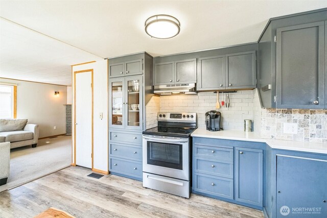 420 3rd St, Ronald, WA 98940 - kitchen with stainless steel electric stove, under cabinet range hood, light wood finished floors, and tasteful backsplash