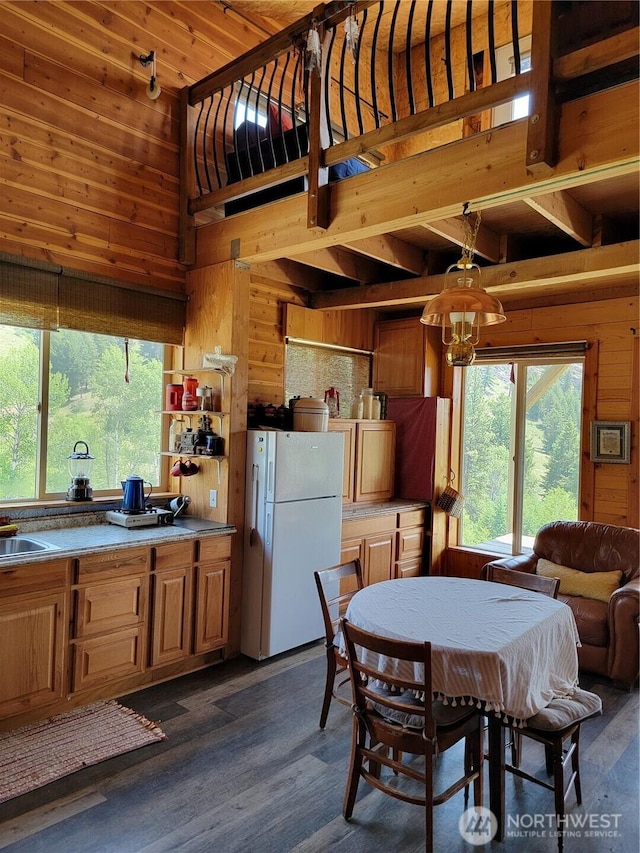 466 Sqove Rd, Wauconda, WA 98859 - dining space with wood walls, dark wood finished floors, a chandelier, and high vaulted ceiling