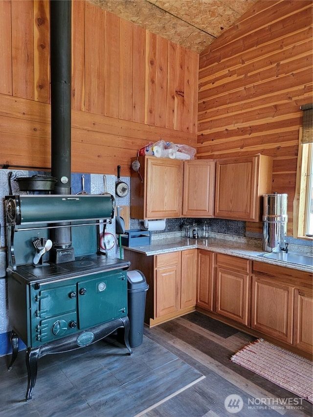 466 Sqove Rd, Wauconda, WA 98859 - kitchen with wood walls, a wood stove, lofted ceiling, light countertops, and dark wood-style floors