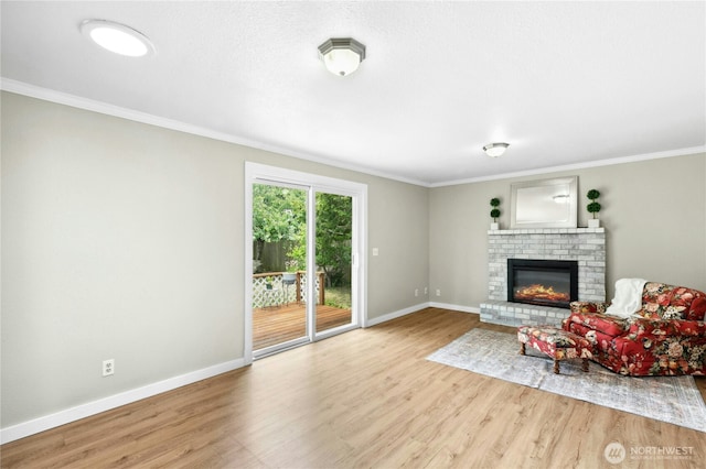 889 SW Kingma Ct, Oak Harbor, WA 98277 - living room featuring a fireplace, wood finished floors, and crown molding