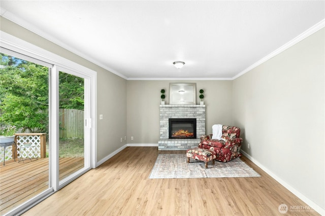 889 SW Kingma Ct, Oak Harbor, WA 98277 - sitting room with wood finished floors, a brick fireplace, and ornamental molding