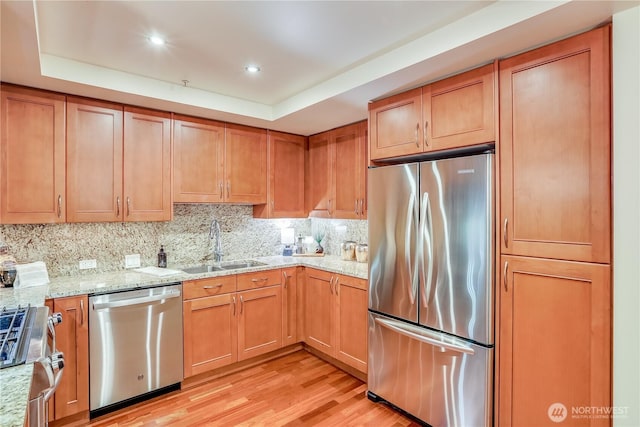 10650 NE 9th Pl Unit 3208, Bellevue, WA 98004 - kitchen featuring stainless steel appliances, tasteful backsplash, light wood-style flooring, light stone counters, and brown cabinetry