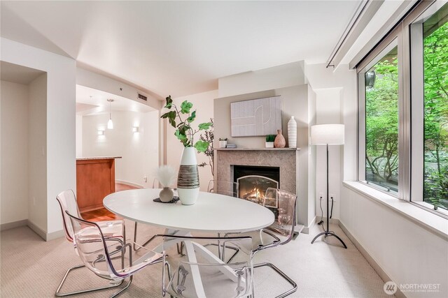 10650 NE 9th Pl Unit 3208, Bellevue, WA 98004 - dining space with baseboards and a high end fireplace