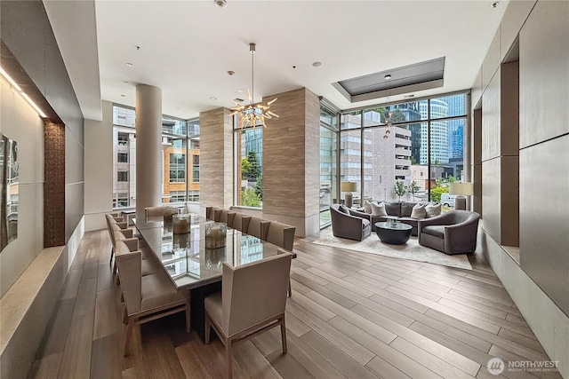 10650 NE 9th Pl Unit 3208, Bellevue, WA 98004 - dining space featuring wood finished floors, expansive windows, a chandelier, and a city view