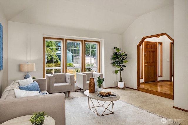 1021 N Sunset Dr, Camano Island, WA 98282 - living room with arched walkways, vaulted ceiling, and carpet