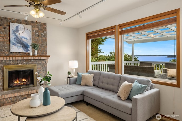 1021 N Sunset Dr, Camano Island, WA 98282 - living area featuring rail lighting, ceiling fan, and a fireplace