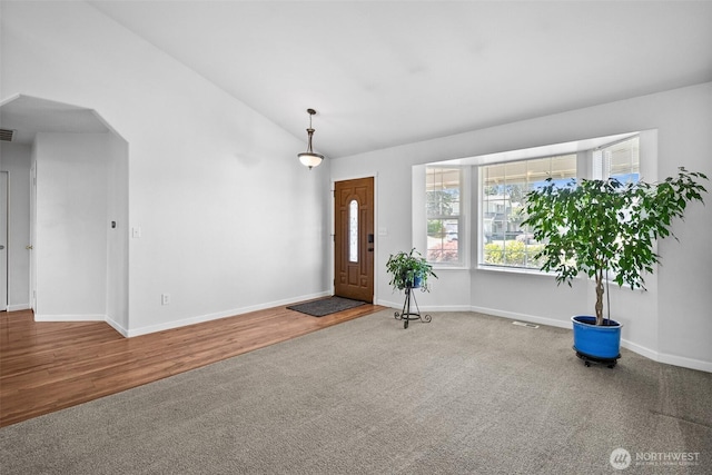 4509 224th Street Ct E, Spanaway, WA 98387 - carpeted foyer entrance with lofted ceiling, wood finished floors, and arched walkways