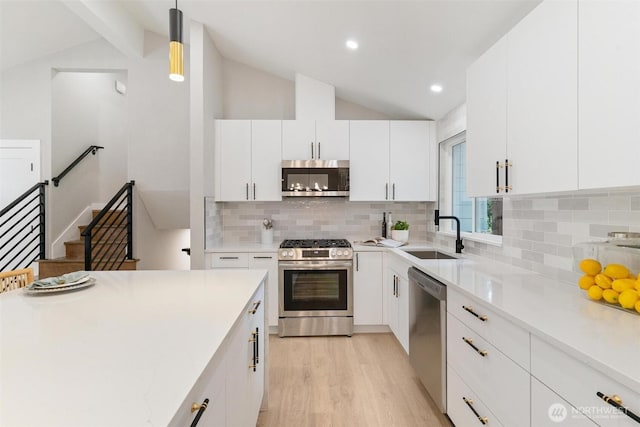 12804 NE 139th Ct, Kirkland, WA 98034 - kitchen with appliances with stainless steel finishes, light wood-style floors, decorative backsplash, white cabinets, and recessed lighting