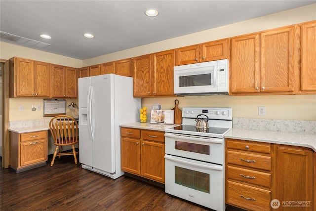 4517 35th St NE, Tacoma, WA 98422 - kitchen with white appliances, built in desk, dark wood-type flooring, recessed lighting, and brown cabinetry