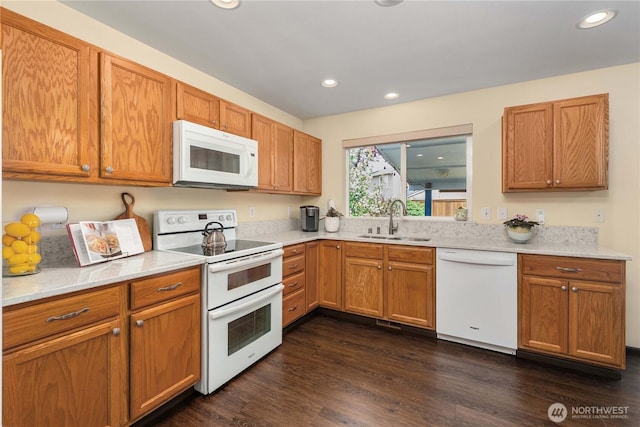4517 35th St NE, Tacoma, WA 98422 - kitchen with white appliances, recessed lighting, dark wood-type flooring, and brown cabinetry