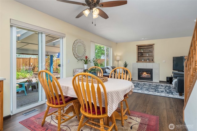 4517 35th St NE, Tacoma, WA 98422 - dining space featuring wood finished floors, ceiling fan, a fireplace, and built in features