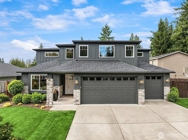 8411 202nd St SW, Edmonds, WA 98026 - prairie-style house with board and batten siding, concrete driveway, stone siding, and an attached garage