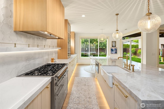 8411 202nd St SW, Edmonds, WA 98026 - kitchen with high end stainless steel range oven, decorative backsplash, recessed lighting, extractor fan, and light wood finished floors