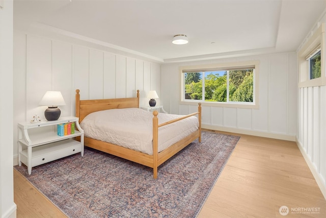 8411 202nd St SW, Edmonds, WA 98026 - bedroom featuring a decorative wall, multiple windows, and wood finished floors