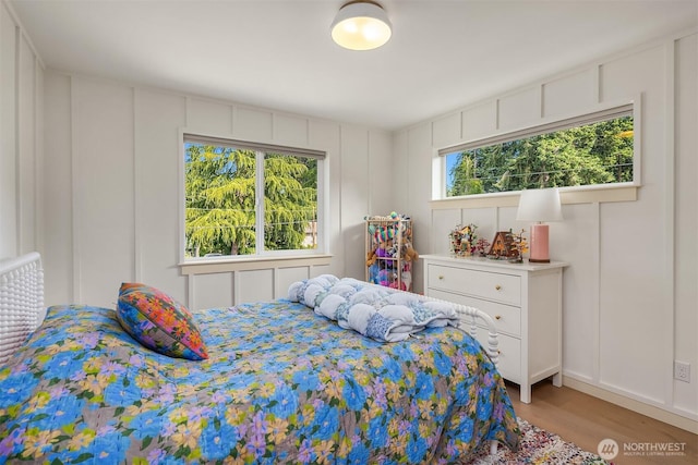 8411 202nd St SW, Edmonds, WA 98026 - bedroom with a decorative wall and light wood finished floors