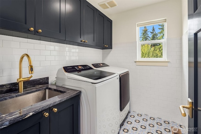 8411 202nd St SW, Edmonds, WA 98026 - laundry room featuring cabinet space, washing machine and dryer, tile walls, and a wainscoted wall