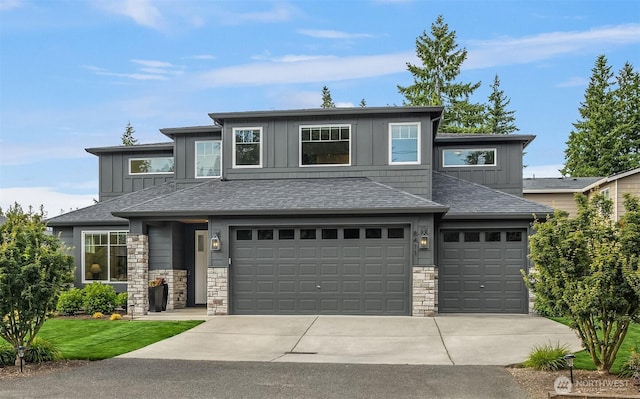 8411 202nd St SW, Edmonds, WA 98026 - prairie-style home featuring board and batten siding, concrete driveway, stone siding, a garage, and a shingled roof