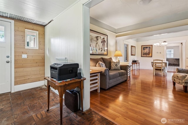 3381 Centralia Alpha Rd, Onalaska, WA 98570 - foyer featuring a chandelier, wooden walls, and wood finished floors
