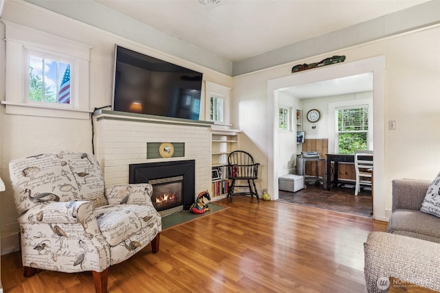 3381 Centralia Alpha Rd, Onalaska, WA 98570 - living area with wood finished floors and a brick fireplace