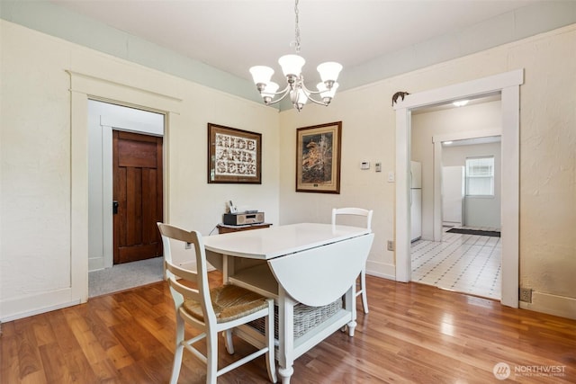 3381 Centralia Alpha Rd, Onalaska, WA 98570 - dining room with a chandelier and light wood-type flooring