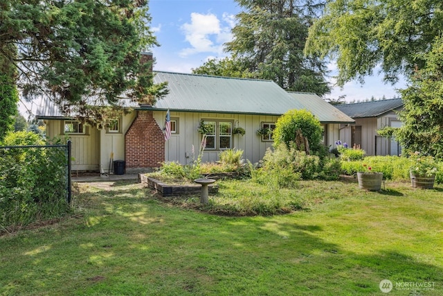 3381 Centralia Alpha Rd, Onalaska, WA 98570 - rear view of property with a yard, board and batten siding, and a metal roof