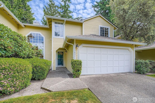 15831 Northup Way Unit 26, Bellevue, WA 98008 - view of front of property with driveway and a garage
