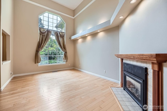 15831 Northup Way Unit 26, Bellevue, WA 98008 - unfurnished living room featuring a fireplace, light wood-style flooring, and recessed lighting