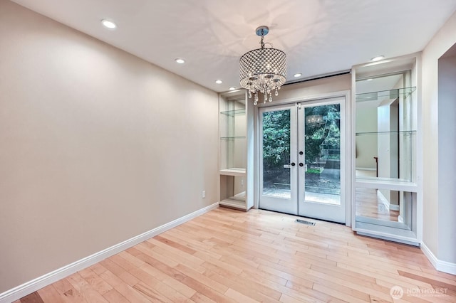 15831 Northup Way Unit 26, Bellevue, WA 98008 - empty room featuring a chandelier, wood finished floors, french doors, and recessed lighting