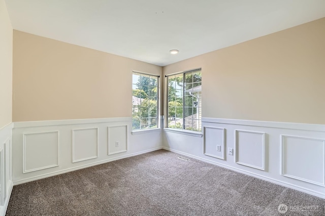 15831 Northup Way Unit 26, Bellevue, WA 98008 - spare room with a wainscoted wall, carpet, and a decorative wall