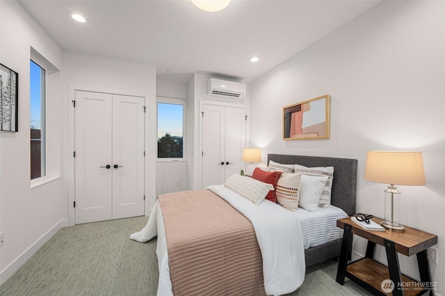 222B 10th Ave E, Seattle, WA 98102 - bedroom with a wall mounted AC, multiple closets, light carpet, and recessed lighting