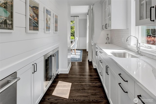 6581 156th Ave SE, Bellevue, WA 98006 - kitchen featuring beverage cooler, dark wood-type flooring, white cabinets, and decorative backsplash