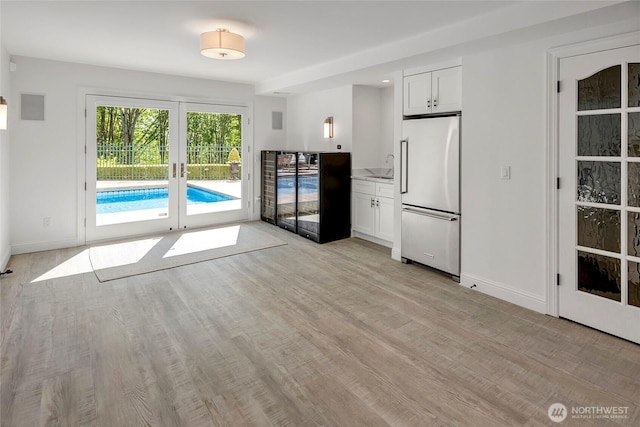 6581 156th Ave SE, Bellevue, WA 98006 - kitchen with high quality fridge, french doors, wine cooler, and light wood-style floors