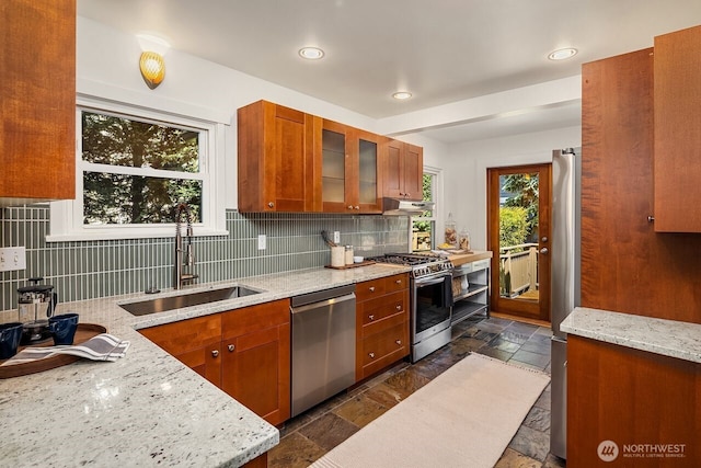 3112 NE 65th St, Seattle, WA 98115 - kitchen with stainless steel appliances, brown cabinets, stone tile floors, tasteful backsplash, and recessed lighting