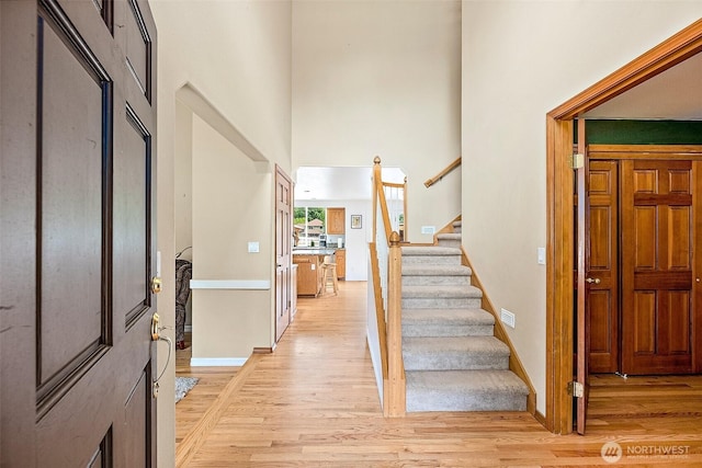 9321 339th St S Unit 5, Roy, WA 98580 - foyer entrance with light wood-type flooring, a high ceiling, and stairway