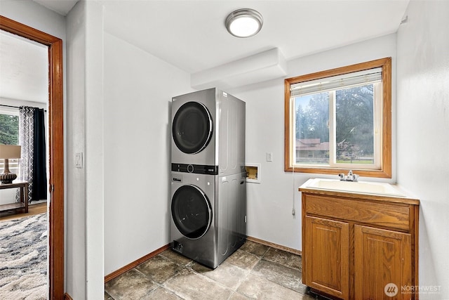 9321 339th St S Unit 5, Roy, WA 98580 - washroom featuring stacked washer / drying machine, cabinet space, and light stone finish floors