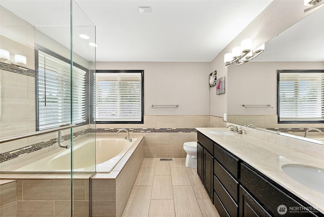 9321 339th St S Unit 5, Roy, WA 98580 - full bath with a bath, double vanity, tile walls, tile patterned floors, and a wainscoted wall